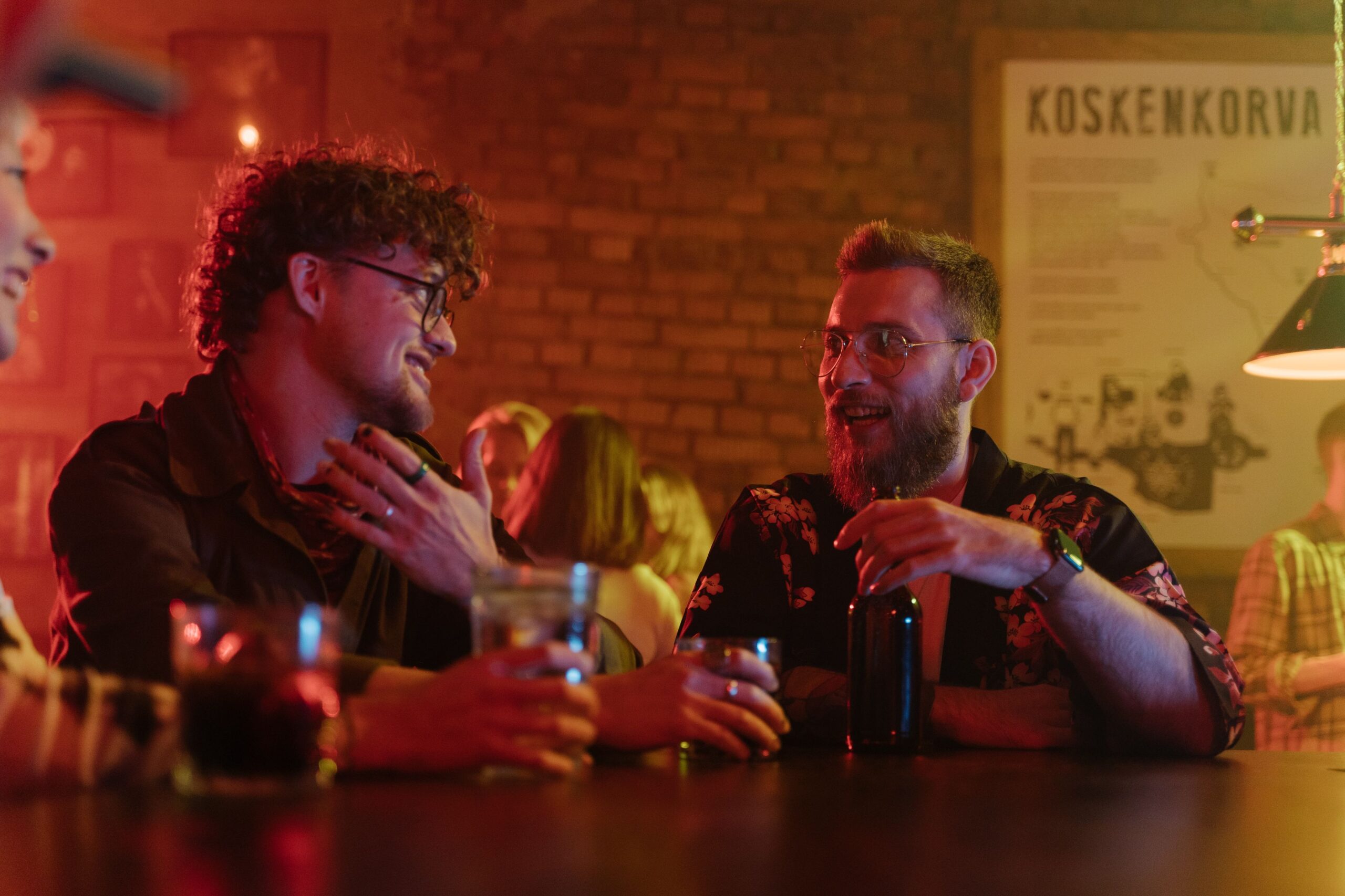 Group of friends having fun and conversation at a lively bar, enjoying nightlife.